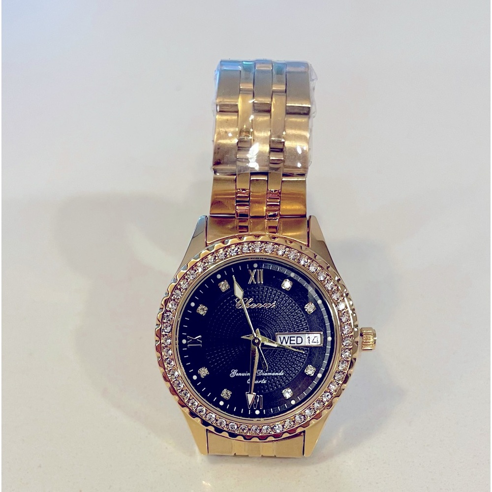 Women’s 24kt gold plated, black dial with CZ  bezel and hour markers. Stunning!
